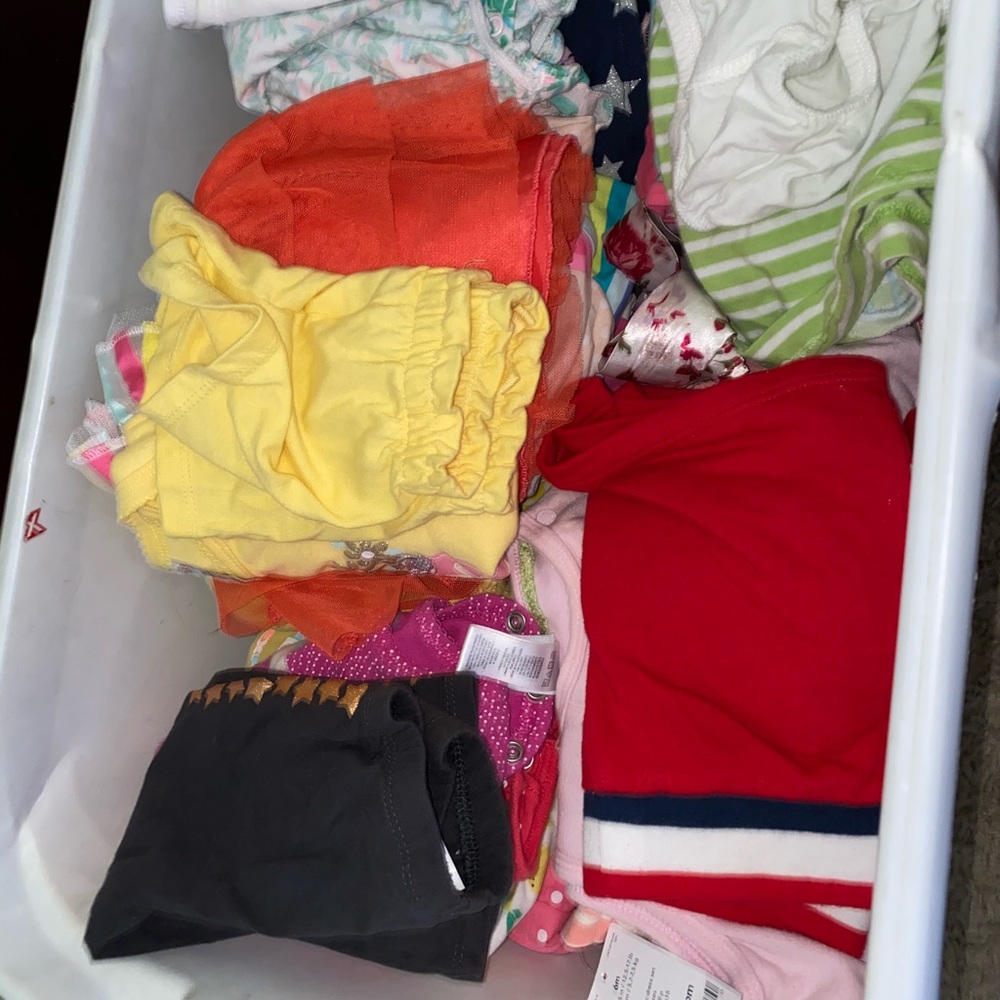 A tube of baby clothes and shoes